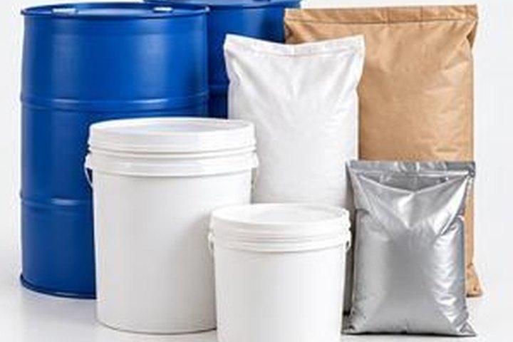 Blue drums, white pails and bags of industrial chemicals